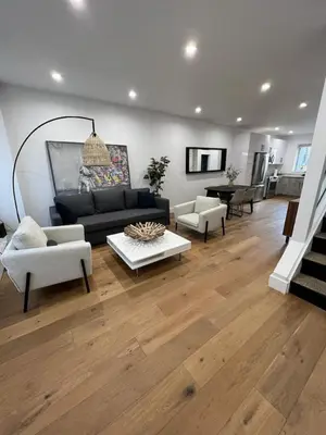 a living room with a couch and chairs and a table at Stunning Family Style Duplex in New York