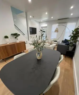 a black table and chairs in a living room at Stunning Family Style Duplex in New York