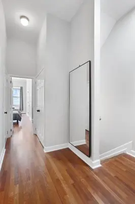 an empty room with a mirror on the wall at Charming Central Park Townhome in New York