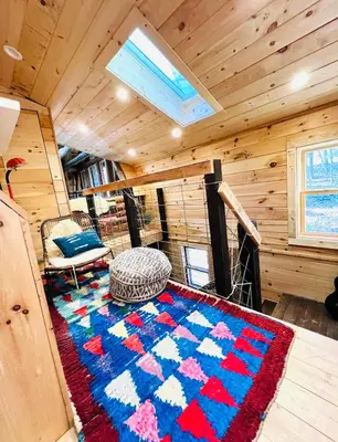 a room with a rug on the floor in a cabin at Cozy, Modern Cabin Retreat 8 min to Windham mtn in Ashland