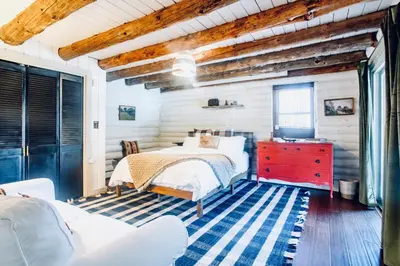 a bedroom with a bed and a red dresser at Cozy, Modern Cabin Retreat 8 min to Windham mtn in Ashland