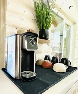 a coffee maker on a black counter with a plant at Cozy, Modern Cabin Retreat 8 min to Windham mtn in Ashland