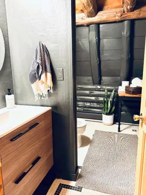 a bathroom with a toilet and a towel on the door at Cozy, Modern Cabin Retreat 8 min to Windham mtn in Ashland