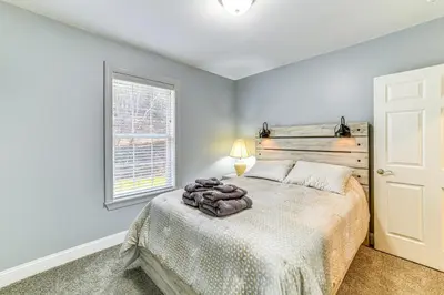a bedroom with a bed and a window at Mountain Views and Brook Access Home in Arkville! in Arkville