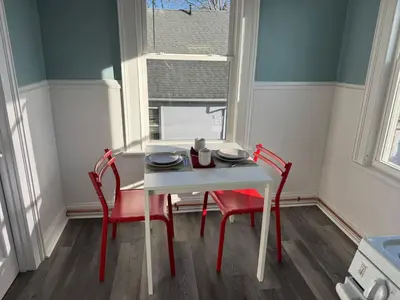 a white table and two red chairs in a room at private room in middletown 4 minute to wesleyan univ in Middletown