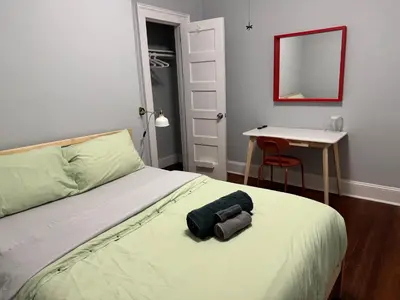 a bedroom with a bed and a table and a mirror at private room in middletown 4 minute to wesleyan univ in Middletown