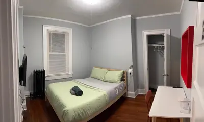 a bedroom with a bed with a hat on it at private room in middletown 4 minute to wesleyan univ in Middletown
