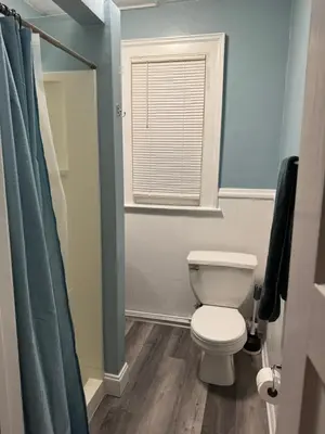a bathroom with a white toilet and a window at private room in middletown 4 minute to wesleyan univ in Middletown