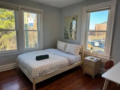 a bedroom with a bed and two windows at private room in middletown 4 minute to wesleyan univ in Middletown