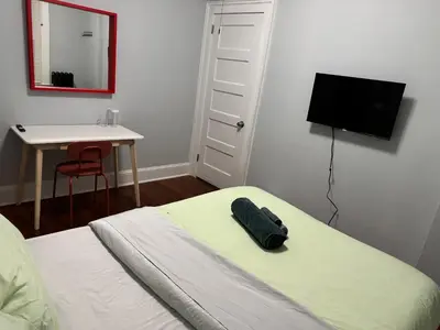 a bedroom with a bed and a desk and a television at private room in middletown 4 minute to wesleyan univ in Middletown