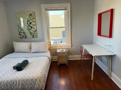 a bedroom with a bed and a desk and a window at private room in middletown 4 minute to wesleyan univ in Middletown