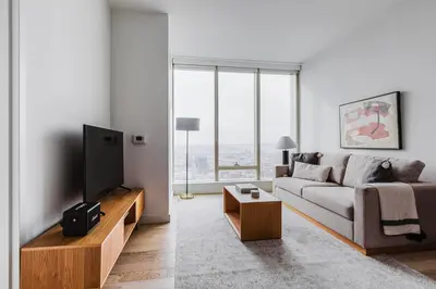 a living room with a couch and a flat screen tv at Blueground Downtown BK gym wd nr BAM NYC-1685 in Brooklyn
