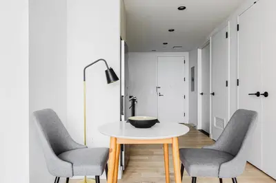 a dining room with a table and two chairs at Blueground Downtown BK gym wd nr BAM NYC-1685 in Brooklyn