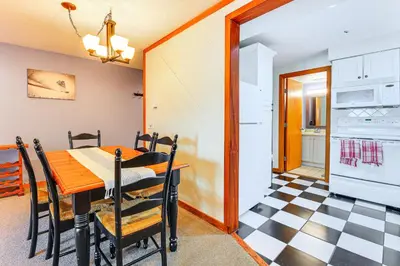 a kitchen and dining room with a table and chairs at Walk to Mt Snow Cozy West Dover Condo in West Dover