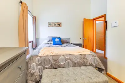 a bedroom with a bed with a blue pillow on it at Walk to Mt Snow Cozy West Dover Condo in West Dover