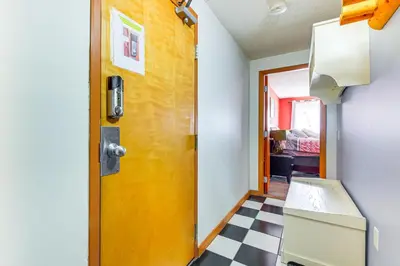 a room with a yellow door and a checkered floor at Walk to Mt Snow Cozy West Dover Condo in West Dover