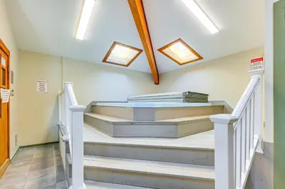 a set of stairs in a room with skylights at Walk to Mt Snow Cozy West Dover Condo in West Dover