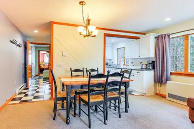 a kitchen and dining room with a table and chairs at Walk to Mt Snow Cozy West Dover Condo in West Dover