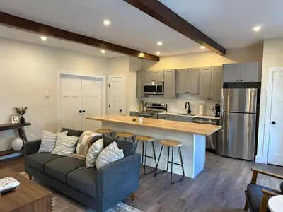 a kitchen and living room with a couch and a counter at The Innwoods - Two Bedroom Apartment in Tannersville