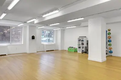 an empty room with a wooden floor and white walls at Blueground Midtown E gym wd nr UN NYC-1150 in New York