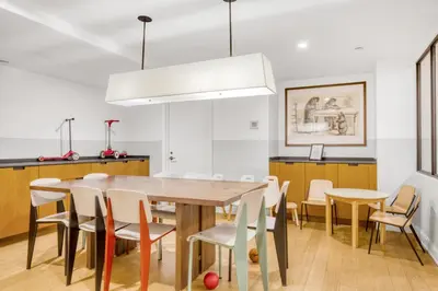 a kitchen and dining room with a wooden table and chairs at Blueground Midtown E gym wd nr UN NYC-1150 in New York