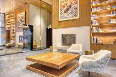 a living room with a wooden table and two chairs at Blueground Midtown E gym wd nr UN NYC-1150 in New York