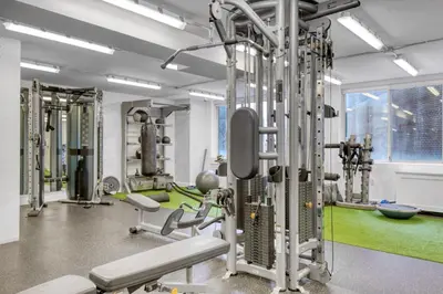 a gym with tread machines and a green floor at Blueground Midtown E gym wd nr UN NYC-1150 in New York