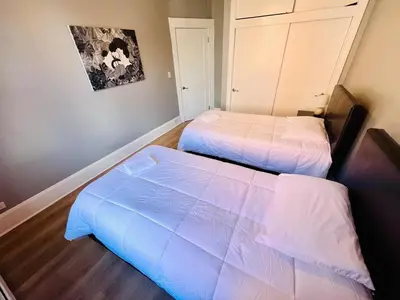 two beds in a small room withermottermott at Spacious 3-bedroom Apartment Stunning Views NYC in Union City