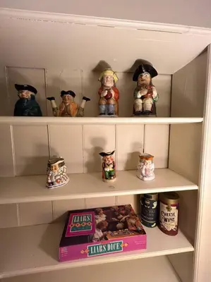 a shelf with figurines and a box of food at The 1782 Darling House on the Litchfield Green in Litchfield