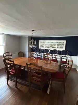 a dining room with a wooden table and chairs at The 1782 Darling House on the Litchfield Green in Litchfield