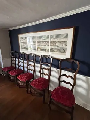 a row of chairs lined up against a wall at The 1782 Darling House on the Litchfield Green in Litchfield