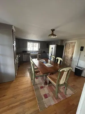 a dining room with a table and chairs and a kitchen at The 1782 Darling House on the Litchfield Green in Litchfield