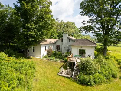 a white house with a staircase leading up to it at Casa Catskills in Margaretville