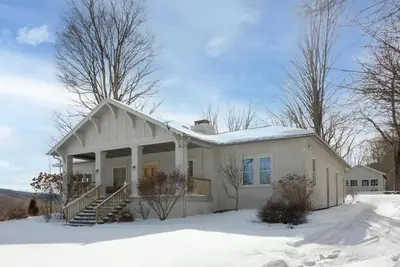a white house with snow on the ground at Casa Catskills in Margaretville