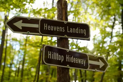 two street signs on a pole in a forest at Campsite 1 at Moon Valley Campground in Vernon Township
