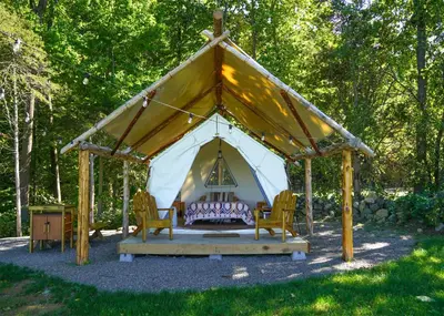 a gazebo with two chairs and a tent at Hilltop Hideaway at Moon Valley Campground in Vernon Township