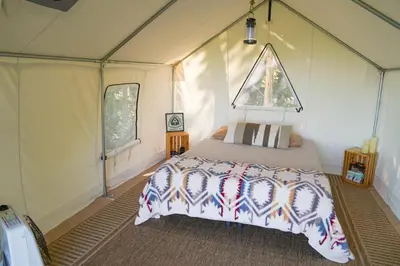 a bedroom with a bed in a tent at Hilltop Hideaway at Moon Valley Campground in Vernon Township