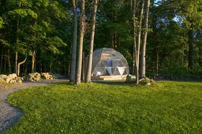 a tent in the middle of a field with trees at The Lookout at Moon Valley Campground in Vernon Township
