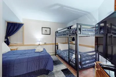 a bedroom with a bed and a bunk bed at Haystack 9 in Wilmington