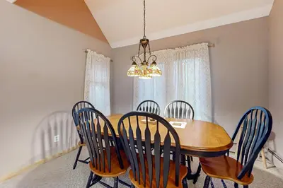 a dining room with a wooden table and chairs at Haystack 9 in Wilmington
