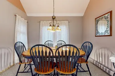 a dining room with a wooden table and chairs at Haystack 9 in Wilmington
