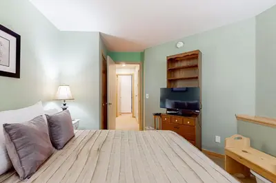 a bedroom with a large bed and a television at Haystack 9 in Wilmington
