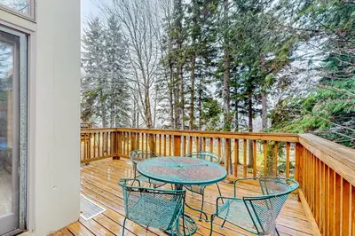 a patio with chairs and a table on a deck at Haystack 9 in Wilmington