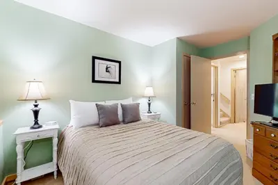 a bedroom with a bed and a flat screen tv at Haystack 9 in Wilmington