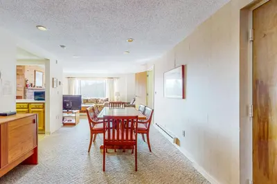 a kitchen and dining room with a table and chairs at Snow Tree 32A in Dover