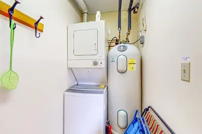a laundry room with a washer and a washing machine at Snow Tree 32A in Dover