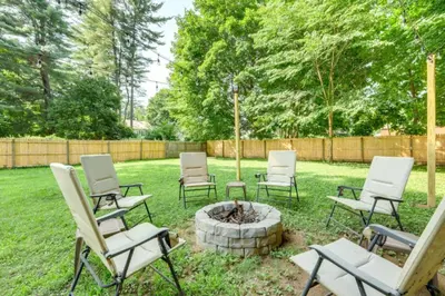 a group of chairs around a fire pit in a yard at Owls Nest Cozy Westfield Home with Fire Pit in Westfield