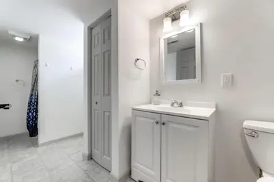 a bathroom with a sink and a mirror and a toilet at Owls Nest Cozy Westfield Home with Fire Pit in Westfield