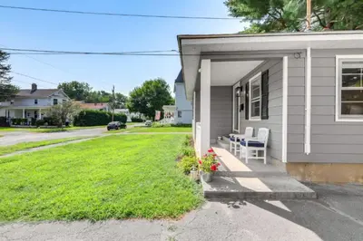 a house with a porch with white chairs and a yard at Owls Nest Cozy Westfield Home with Fire Pit in Westfield