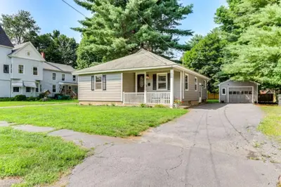 a small house with a porch and a driveway at Owls Nest Cozy Westfield Home with Fire Pit in Westfield